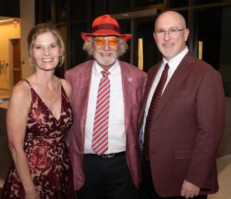 Herbert Wertheim, center, with Dean Michael Hartline and Hartline's wife, Marsha