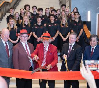 Dignitaries cut the ribbon on the new building.