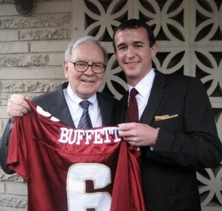 Cody Lewis, right, with Warren Buffett, who's holding an FSU jersey that says "Buffett" on the back