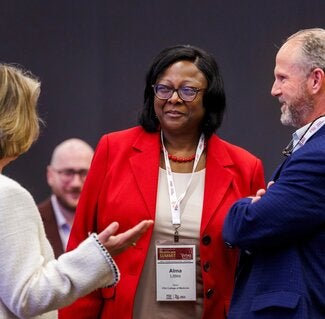 Three business professionals talking during a conference